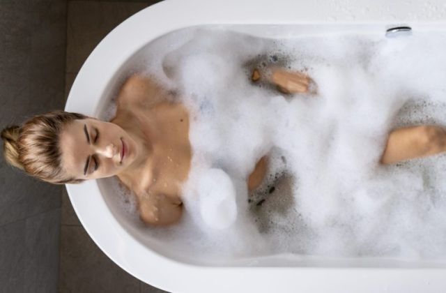 woman enjoying relaxing bubble bath scaled e1676298301681 c4c88d24